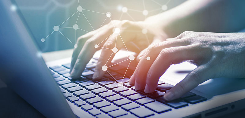 Man's hands, typing on a laptop